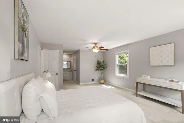 a spacious bedroom with a bed and a chandelier