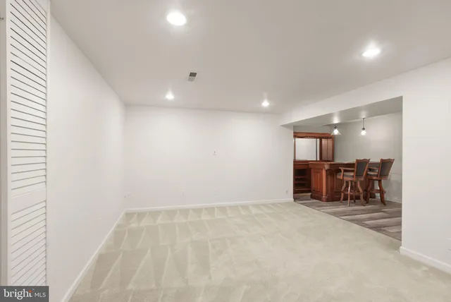 a view of a patio with couple of chairs and potted plants