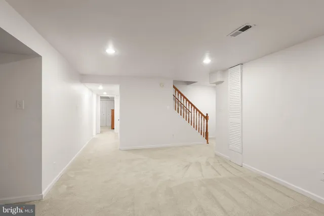 a front view of a house with a garden and plants