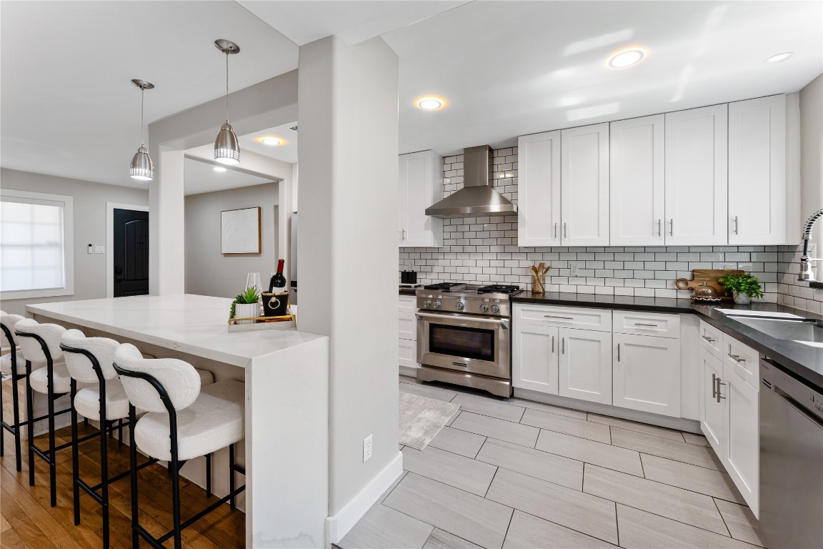 6623 Housman Houston, TX 77055 - Photo 13 of 38 a kitchen with granite countertop a stove a sink and a refrigerator