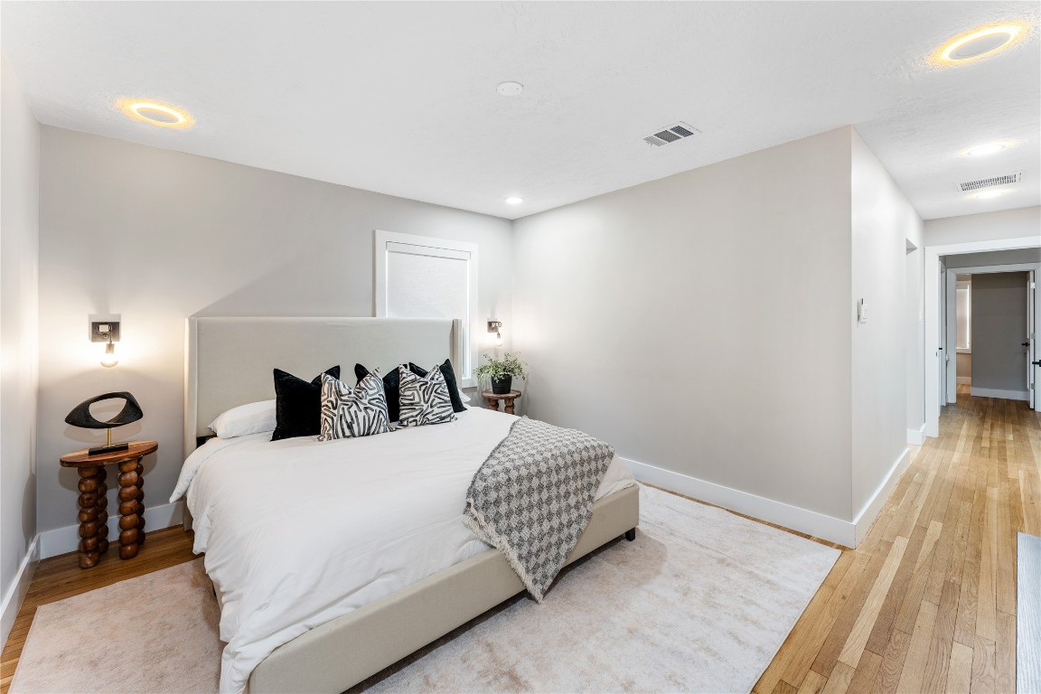 6623 Housman Houston, TX 77055 - Photo 21 of 38 a bedroom with a bed and a wooden floor