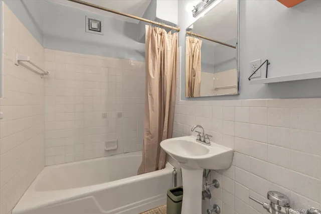 a bathroom with a sink a mirror and a bathtub