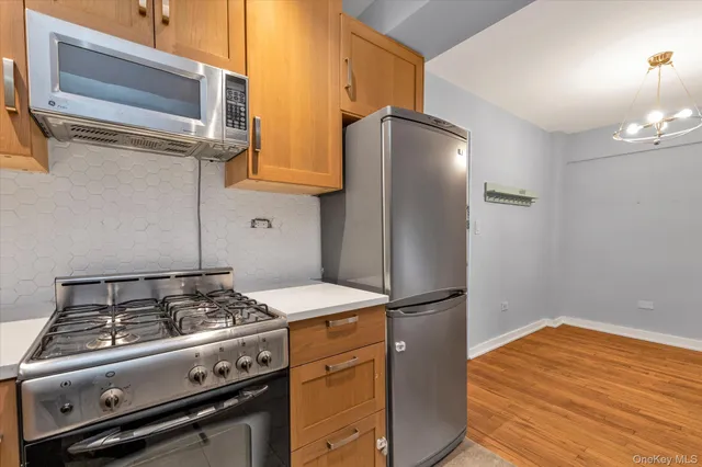 a kitchen with stainless steel appliances granite countertop a stove and a refrigerator