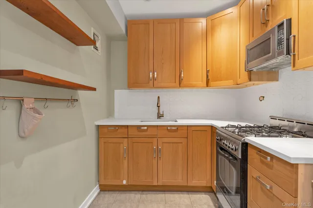 a kitchen with a sink a stove and cabinets