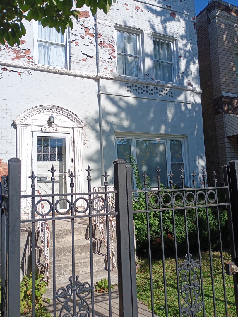 a front view of a building with glass windows and a table
