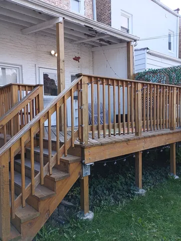 a view of balcony with wooden floor and fence