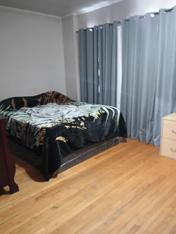 a bedroom with a bed and a curtain