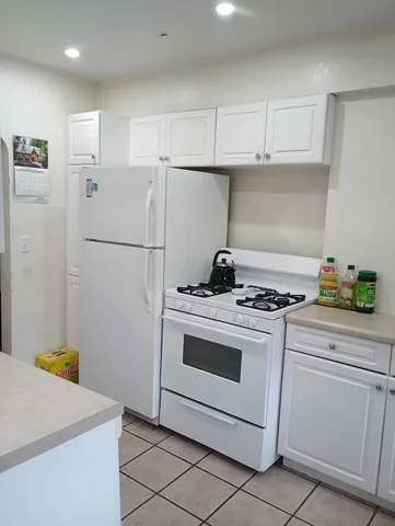 a kitchen with a stove and a refrigerator