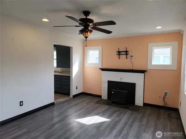 a kitchen with granite countertop a refrigerator stove and sink