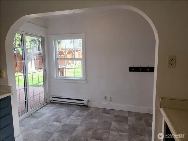 a bathroom view of a toilet and a mirror