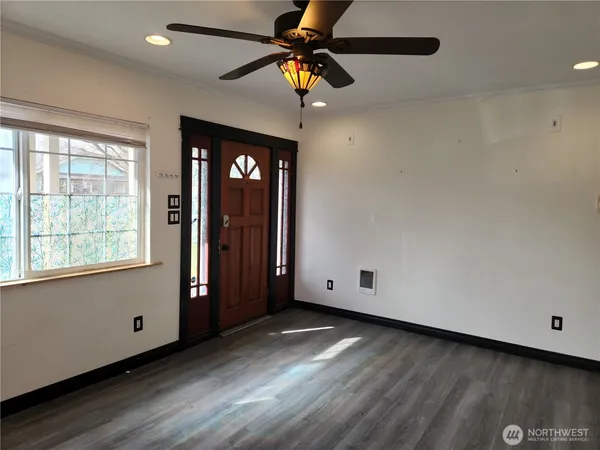 a kitchen with a stove cabinets and wooden floor