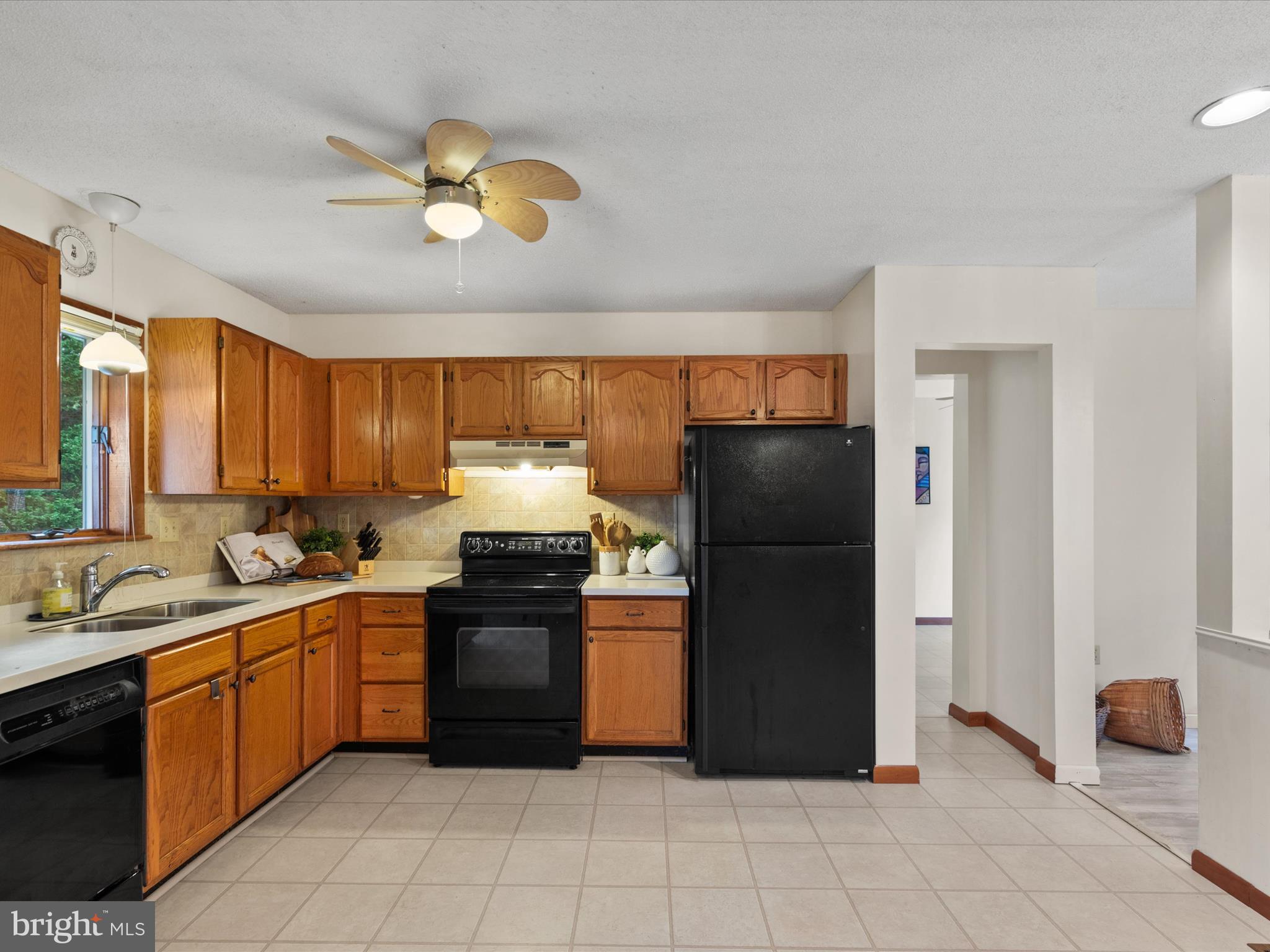 13374 Cove Landing Road Bishopville, MD 21813 - Photo 23 of 108 a kitchen with a refrigerator and a sink