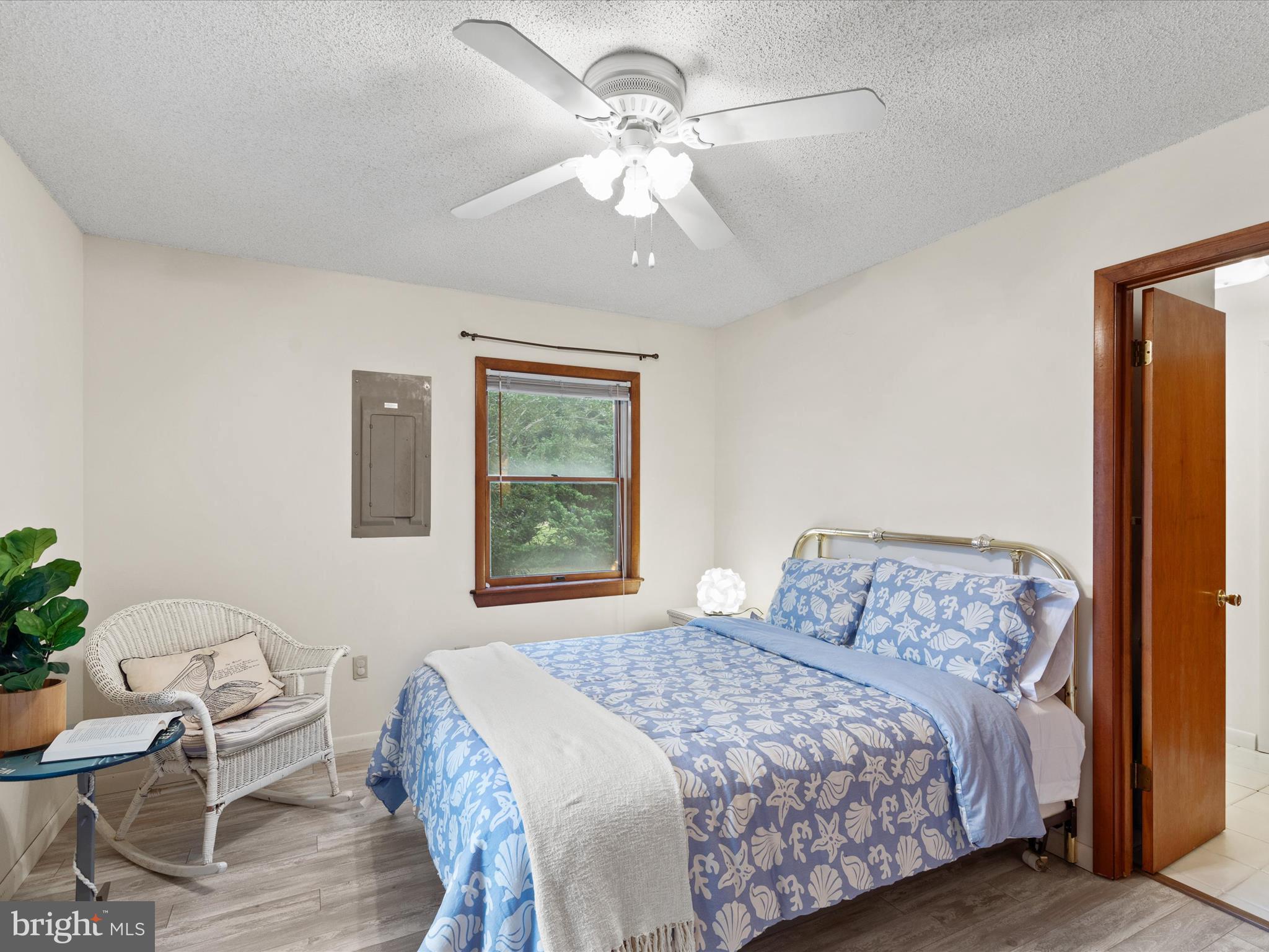 13374 Cove Landing Road Bishopville, MD 21813 - Photo 31 of 108 a bedroom with a bed and a chandelier
