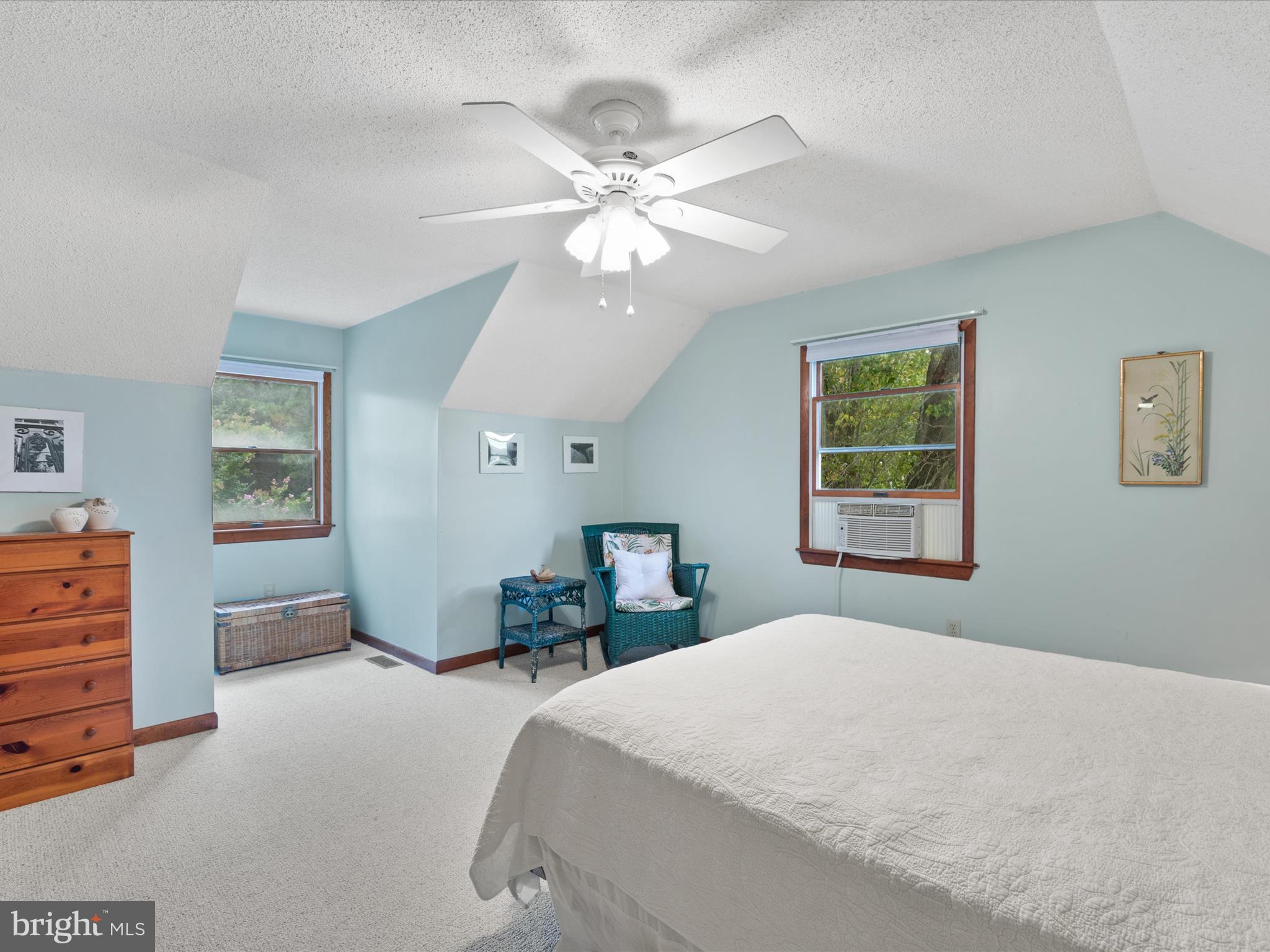 13374 Cove Landing Road Bishopville, MD 21813 - Photo 45 of 108 a bedroom with a large bed and a chandelier