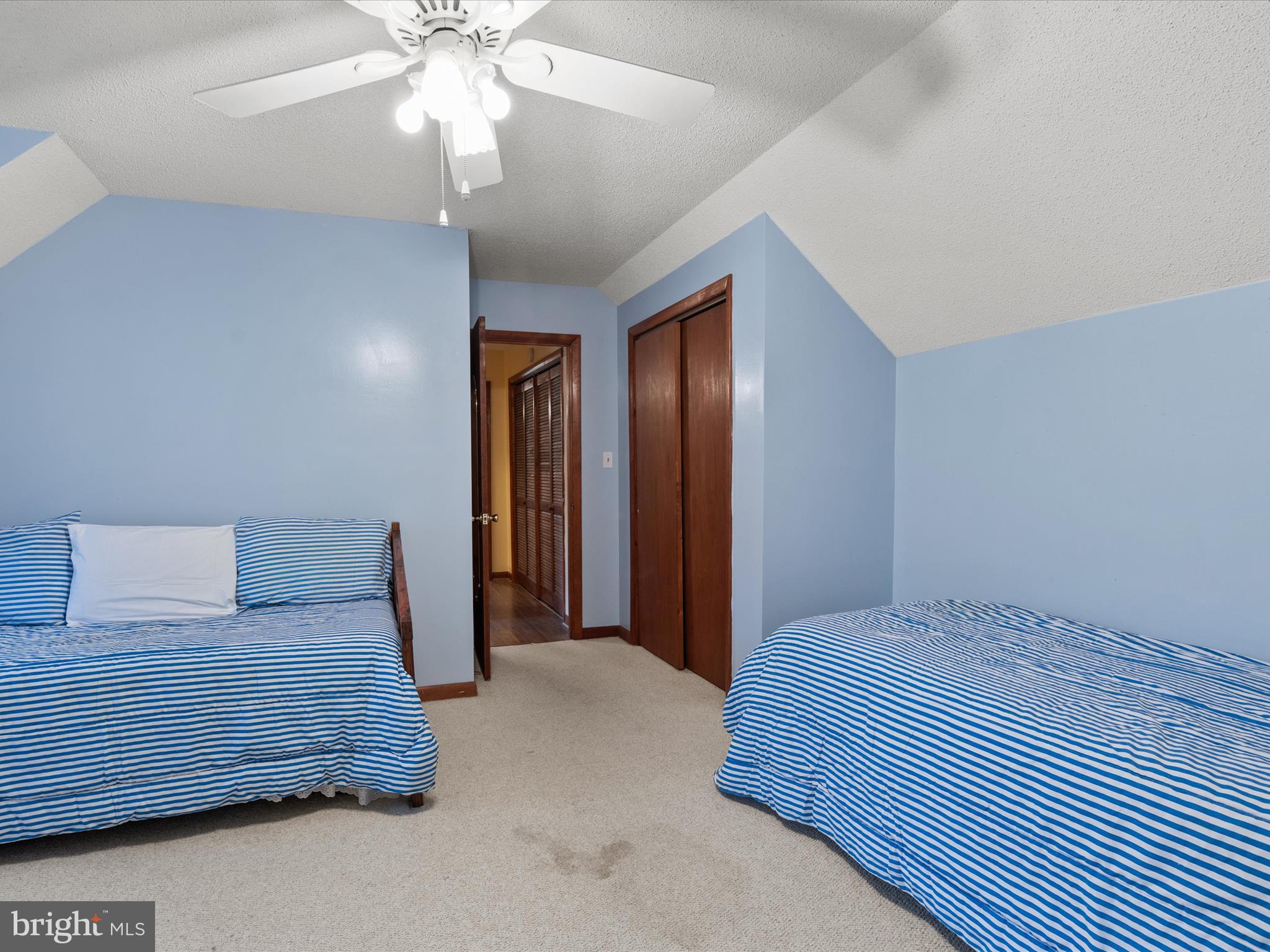 13374 Cove Landing Road Bishopville, MD 21813 - Photo 54 of 108 a bedroom with a bed and a chandelier