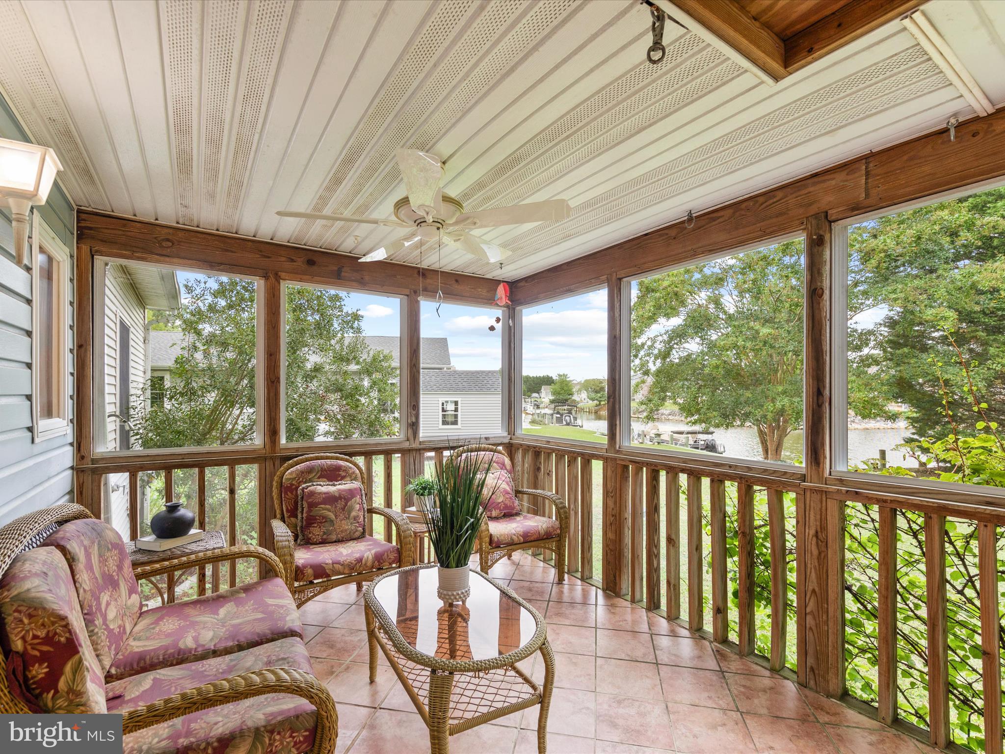 13374 Cove Landing Road Bishopville, MD 21813 - Photo 65 of 108 a living room with furniture and a floor to ceiling window