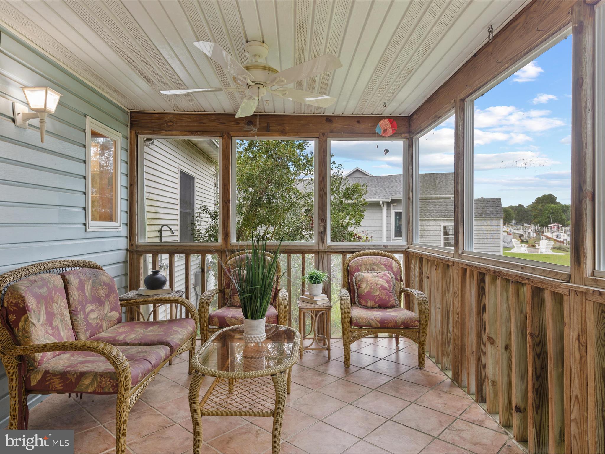 13374 Cove Landing Road Bishopville, MD 21813 - Photo 69 of 108 a living room with furniture and floor to ceiling windows