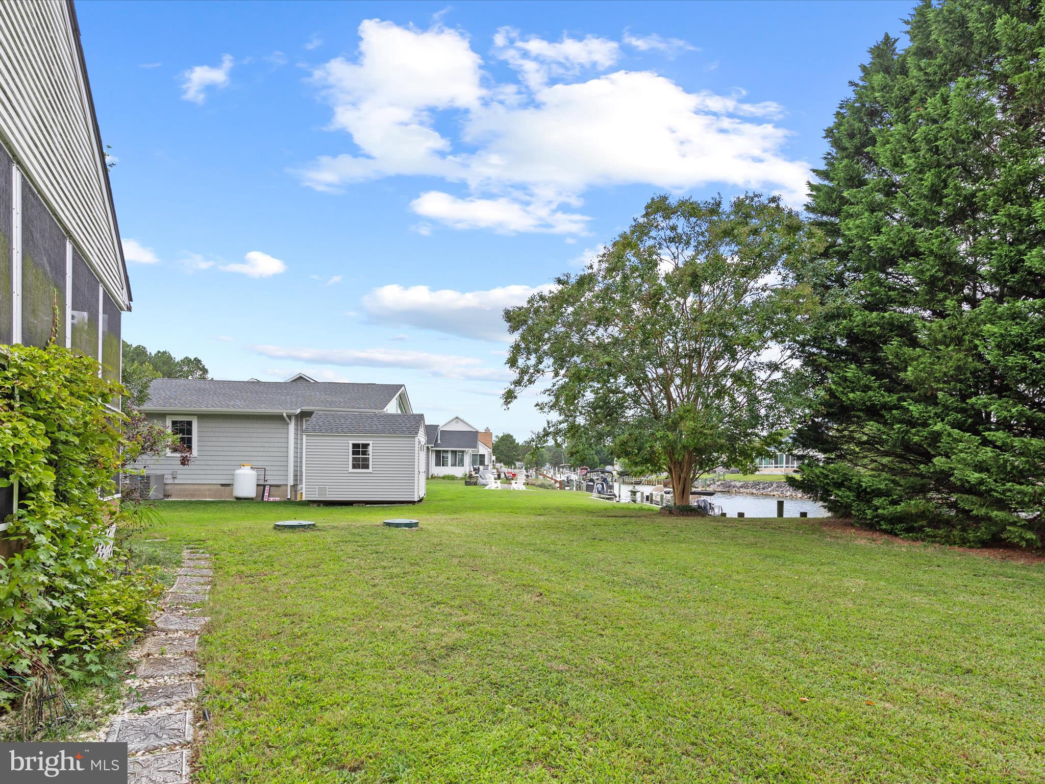 13374 Cove Landing Road Bishopville, MD 21813 - Photo 71 of 108 a view of a house with a big yard and large trees