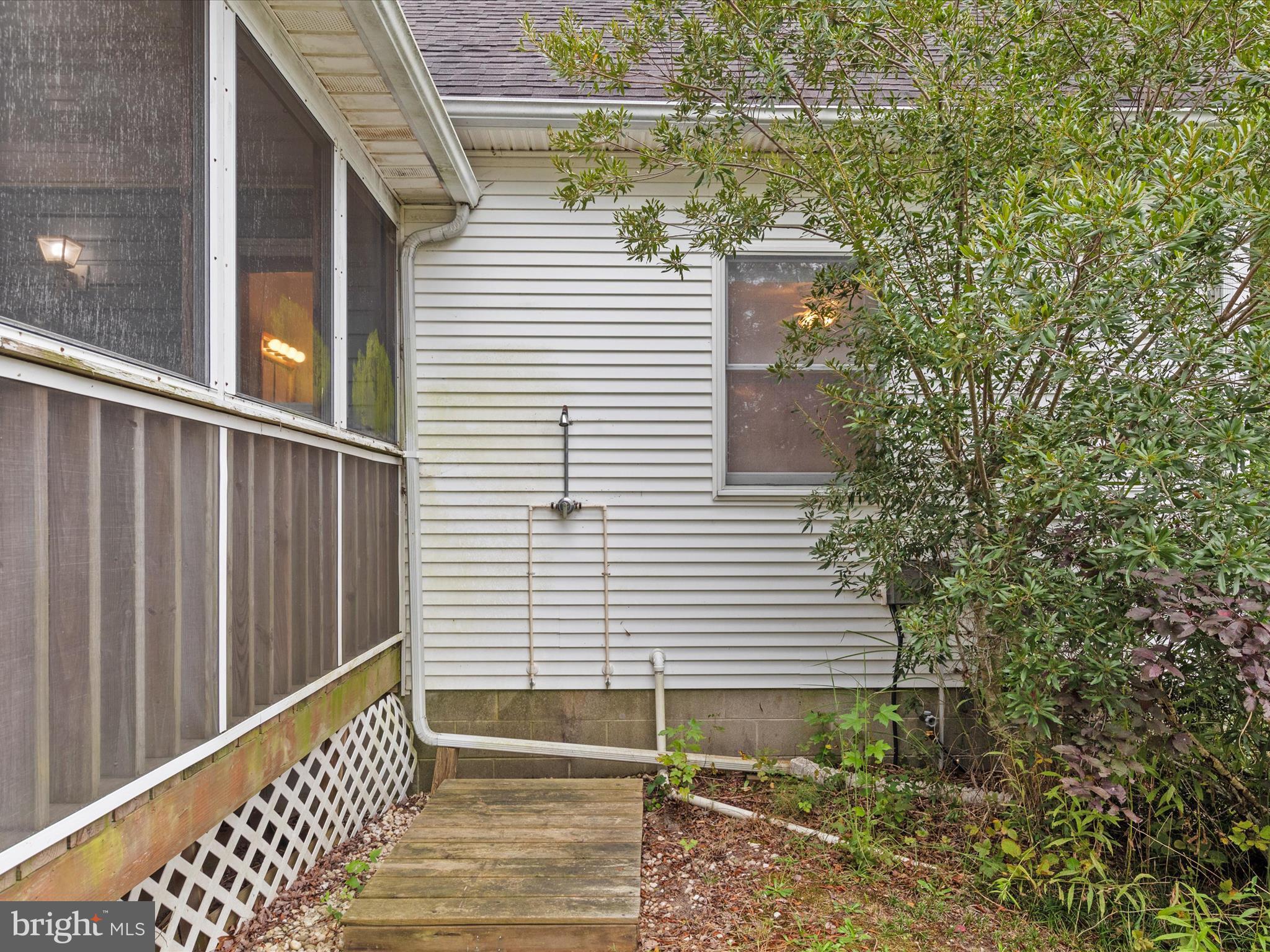 13374 Cove Landing Road Bishopville, MD 21813 - Photo 74 of 108 a view of a balcony with a potted plant and stairs