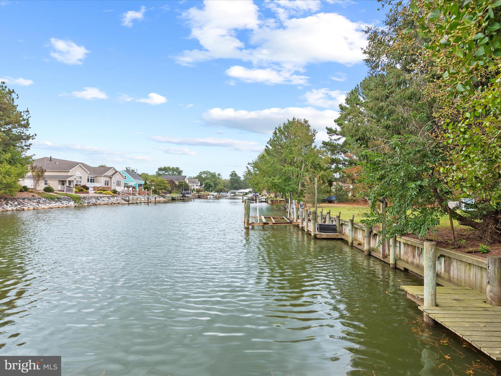 13374 Cove Landing Road Bishopville, MD 21813 - Photo 83 of 108 a view of water with boats and trees in the background