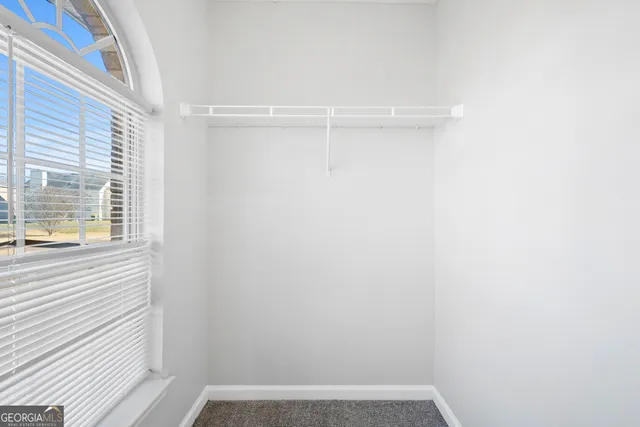 a view of a small space with wooden floor and a window