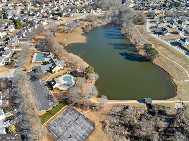 an aerial view of a house with a yard