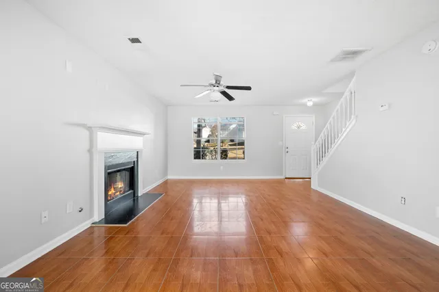 wooden floor in an empty room with a fireplace