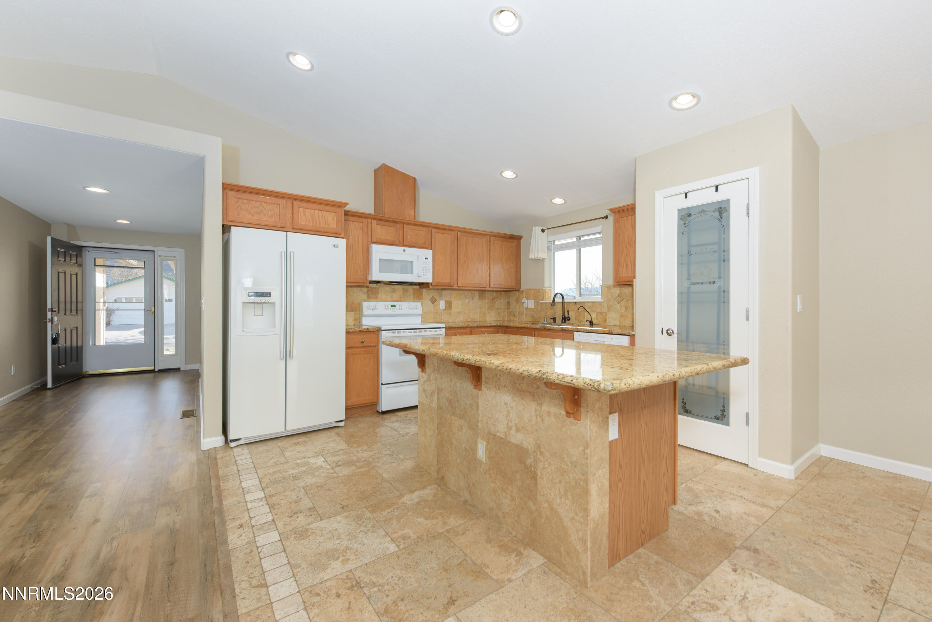 44 Conner Way Gardnerville, NV 89410 - Photo 14 of 38 a kitchen with stainless steel appliances kitchen island granite countertop a refrigerator and a sink