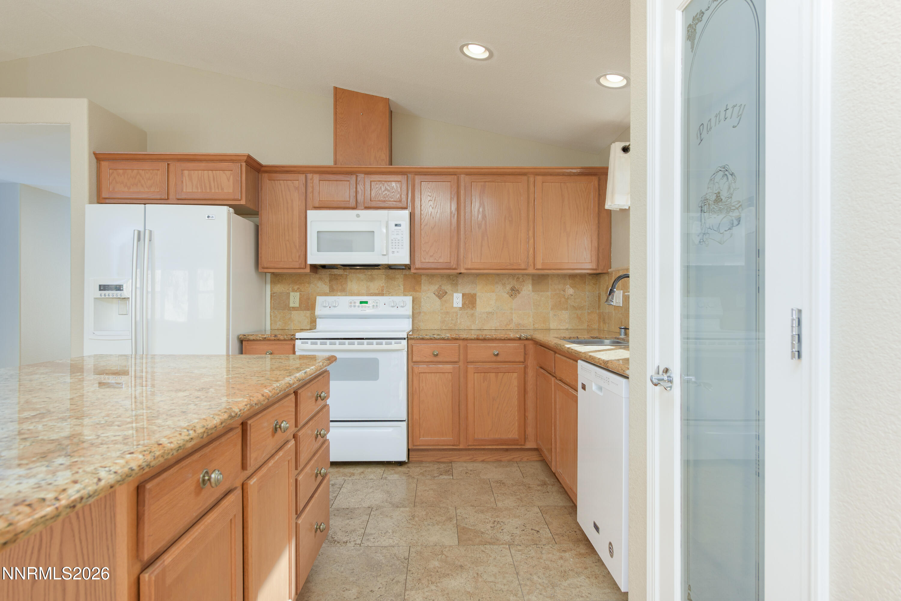 44 Conner Way Gardnerville, NV 89410 - Photo 17 of 38 a kitchen with white cabinets and stainless steel appliances