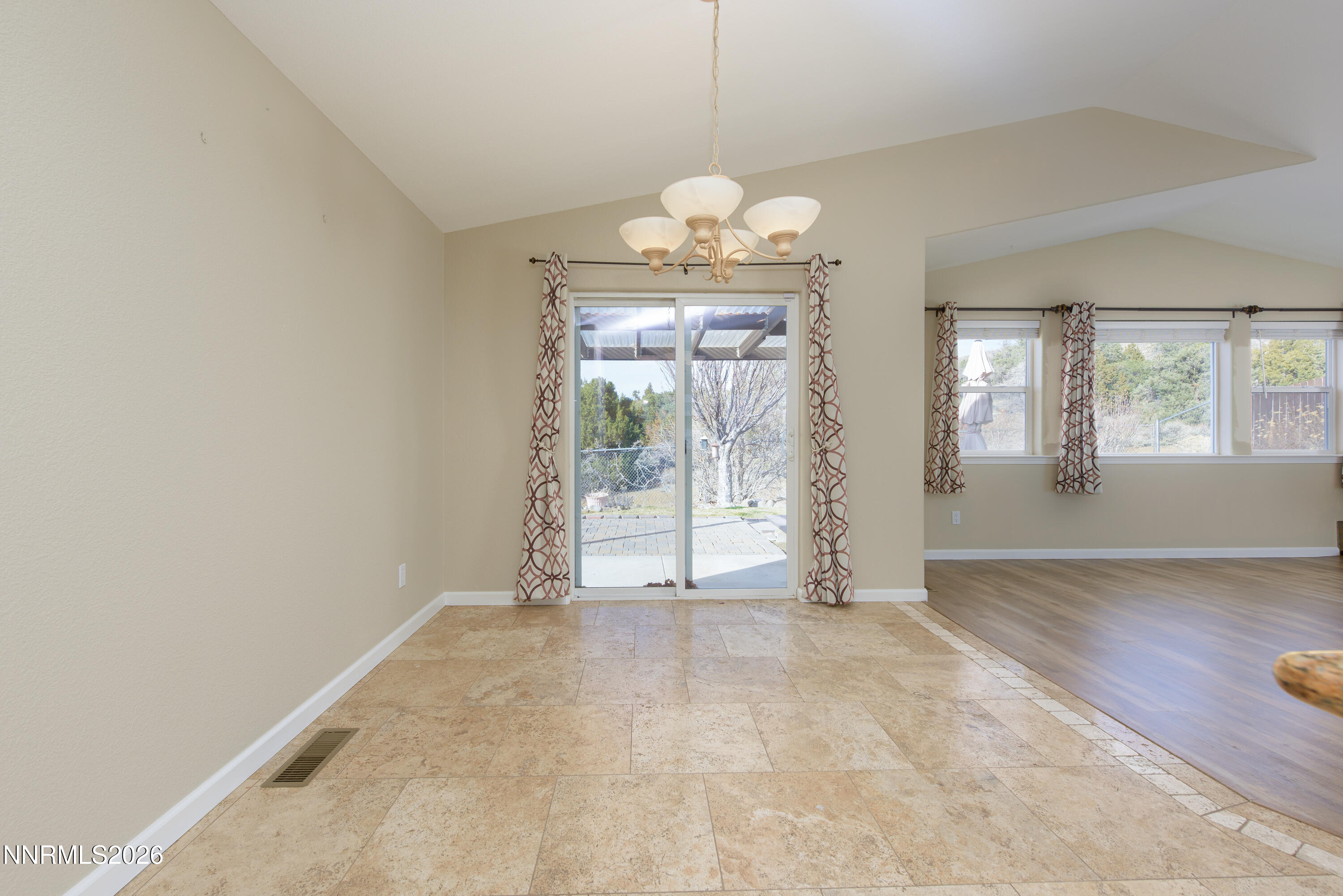 44 Conner Way Gardnerville, NV 89410 - Photo 18 of 38 an empty room with windows and chandelier
