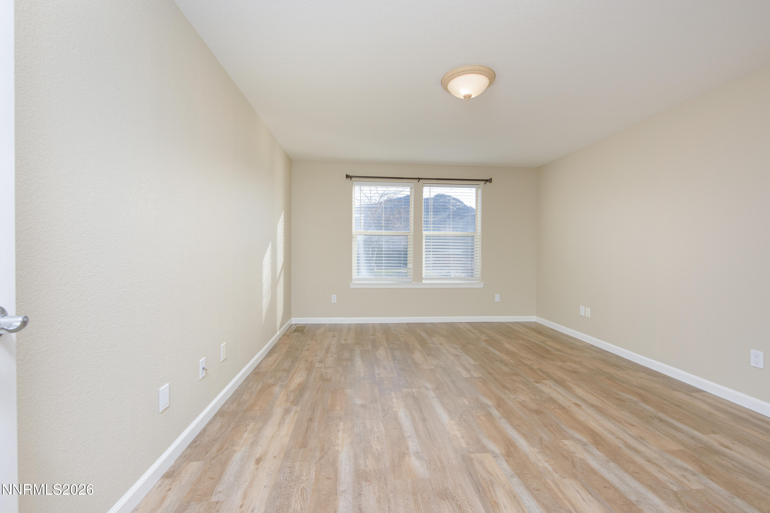 44 Conner Way Gardnerville, NV 89410 - Photo 20 of 38 an empty room with wooden floor and windows