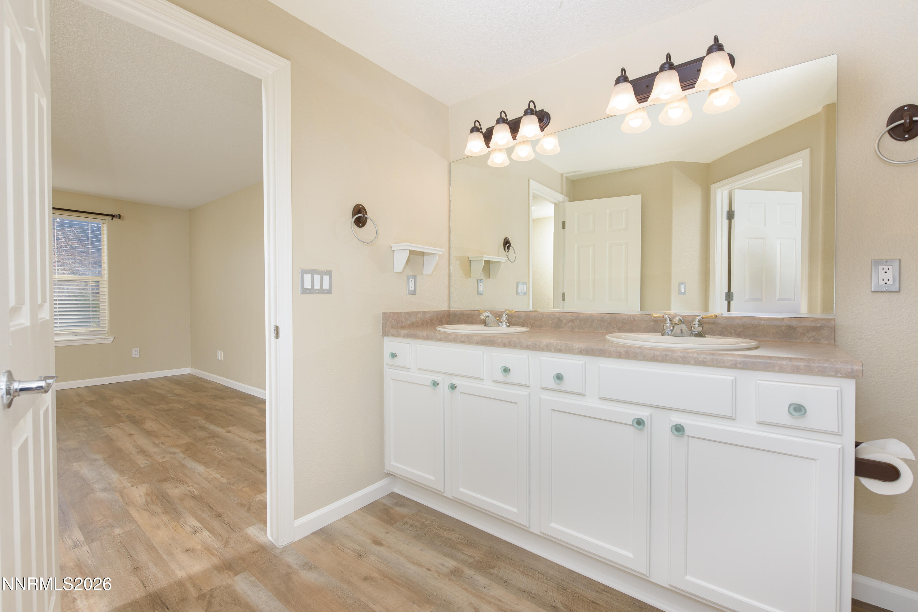 44 Conner Way Gardnerville, NV 89410 - Photo 22 of 38 a bathroom with a sink and a mirror