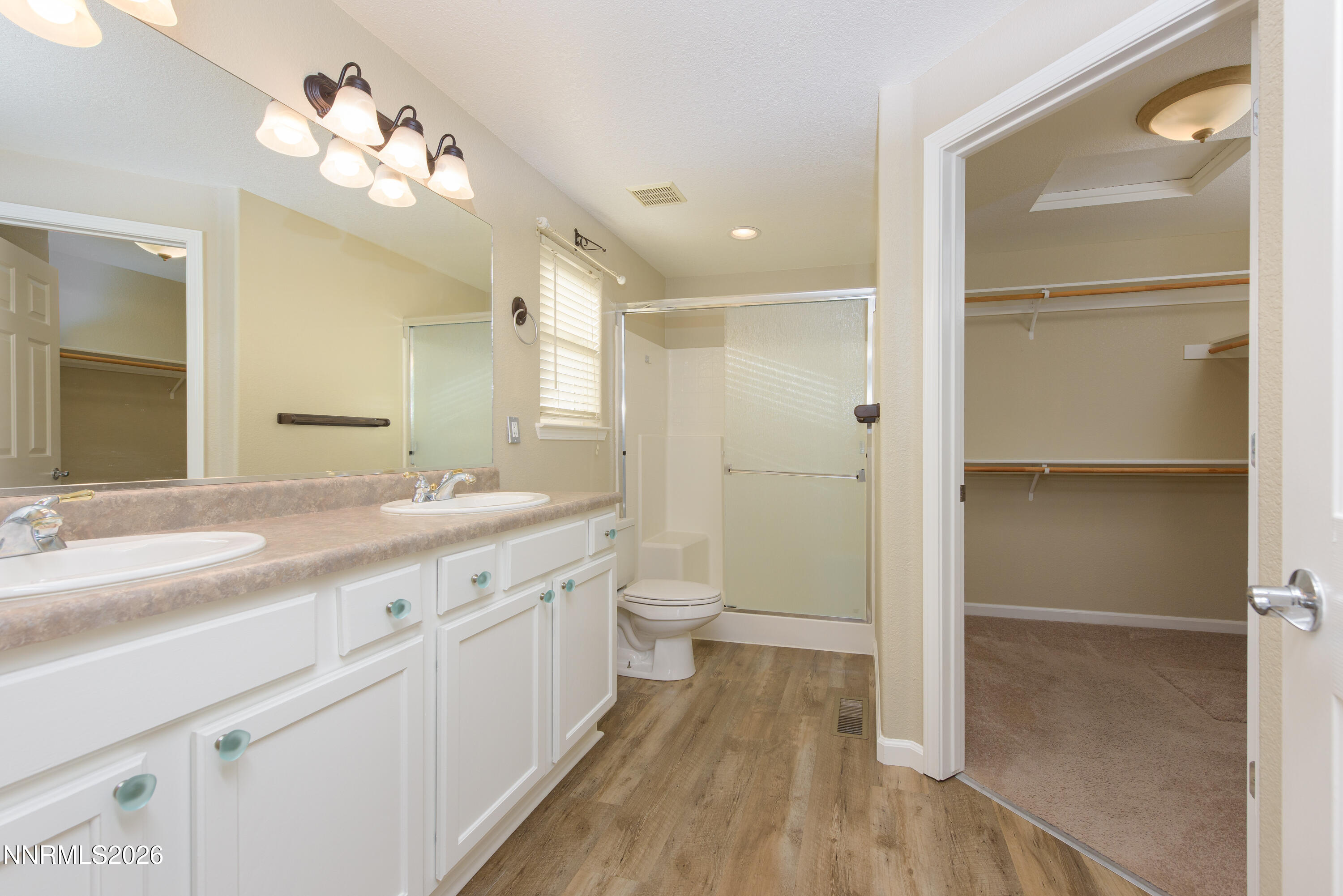 44 Conner Way Gardnerville, NV 89410 - Photo 23 of 38 a spacious bathroom with a shower sink vanity and a mirror