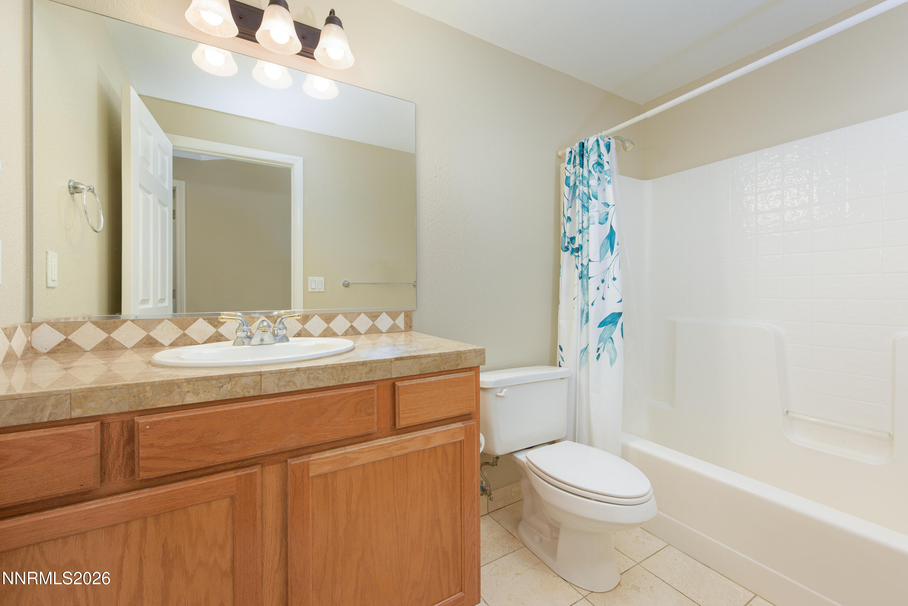 44 Conner Way Gardnerville, NV 89410 - Photo 26 of 38 a bathroom with a sink a toilet a mirror and shower