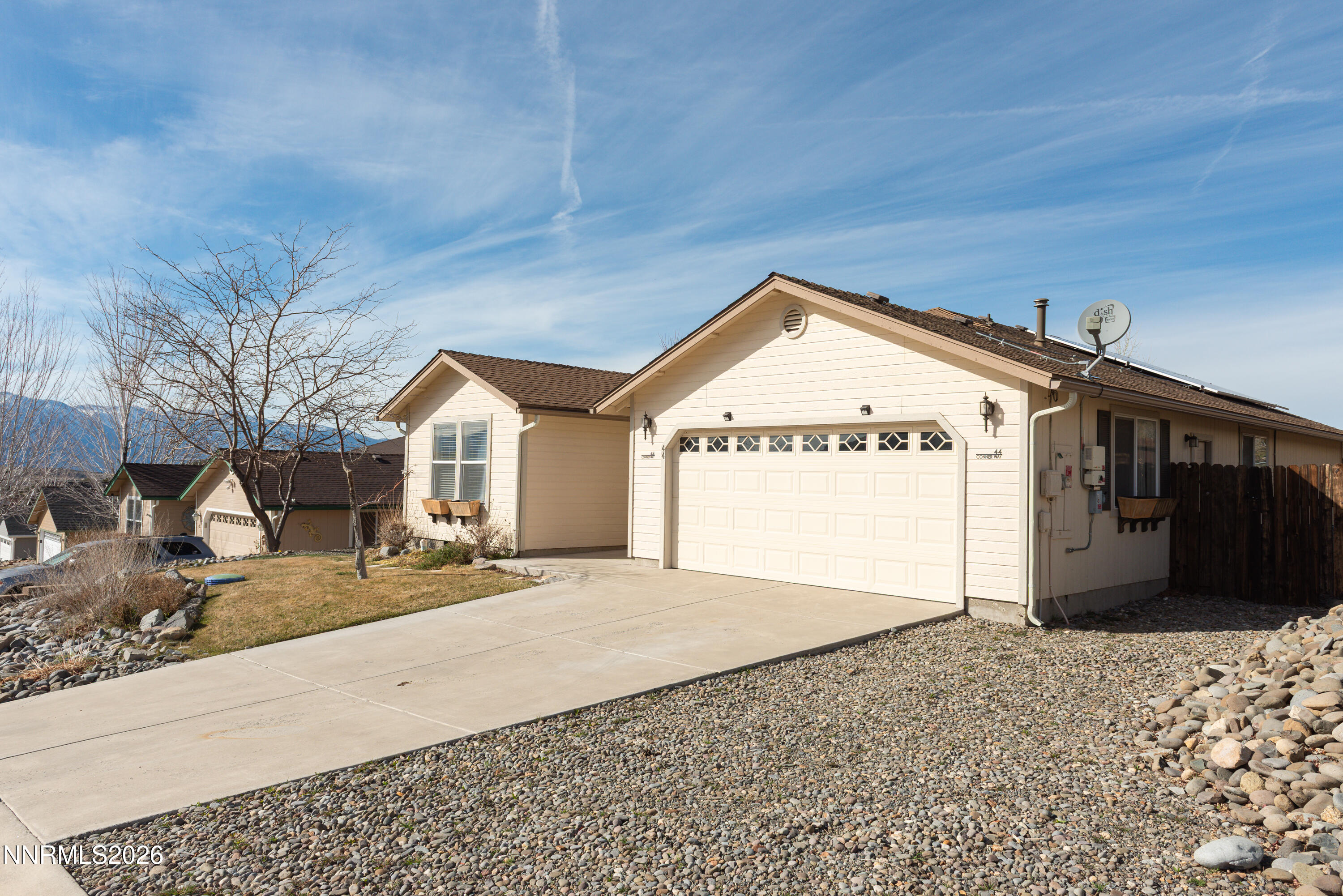 44 Conner Way Gardnerville, NV 89410 - Photo 3 of 38 a view of a house with a dirt road and front door