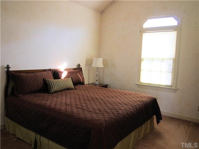 2900 Bannf Court Raleigh, NC 27604 - Photo 11 of 19 a bedroom with a bed and window
