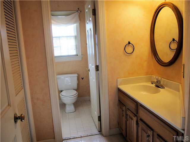2900 Bannf Court Raleigh, NC 27604 - Photo 15 of 19 a bathroom with a granite countertop toilet sink and mirror