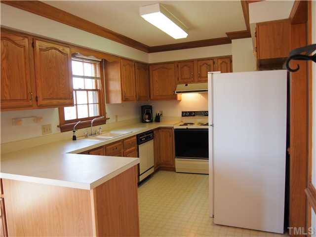 2900 Bannf Court Raleigh, NC 27604 - Photo 8 of 19 a kitchen with a refrigerator a sink and a stove