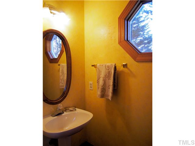 2900 Bannf Court Raleigh, NC 27604 - Photo 10 of 19 a bathroom with a sink and a mirror