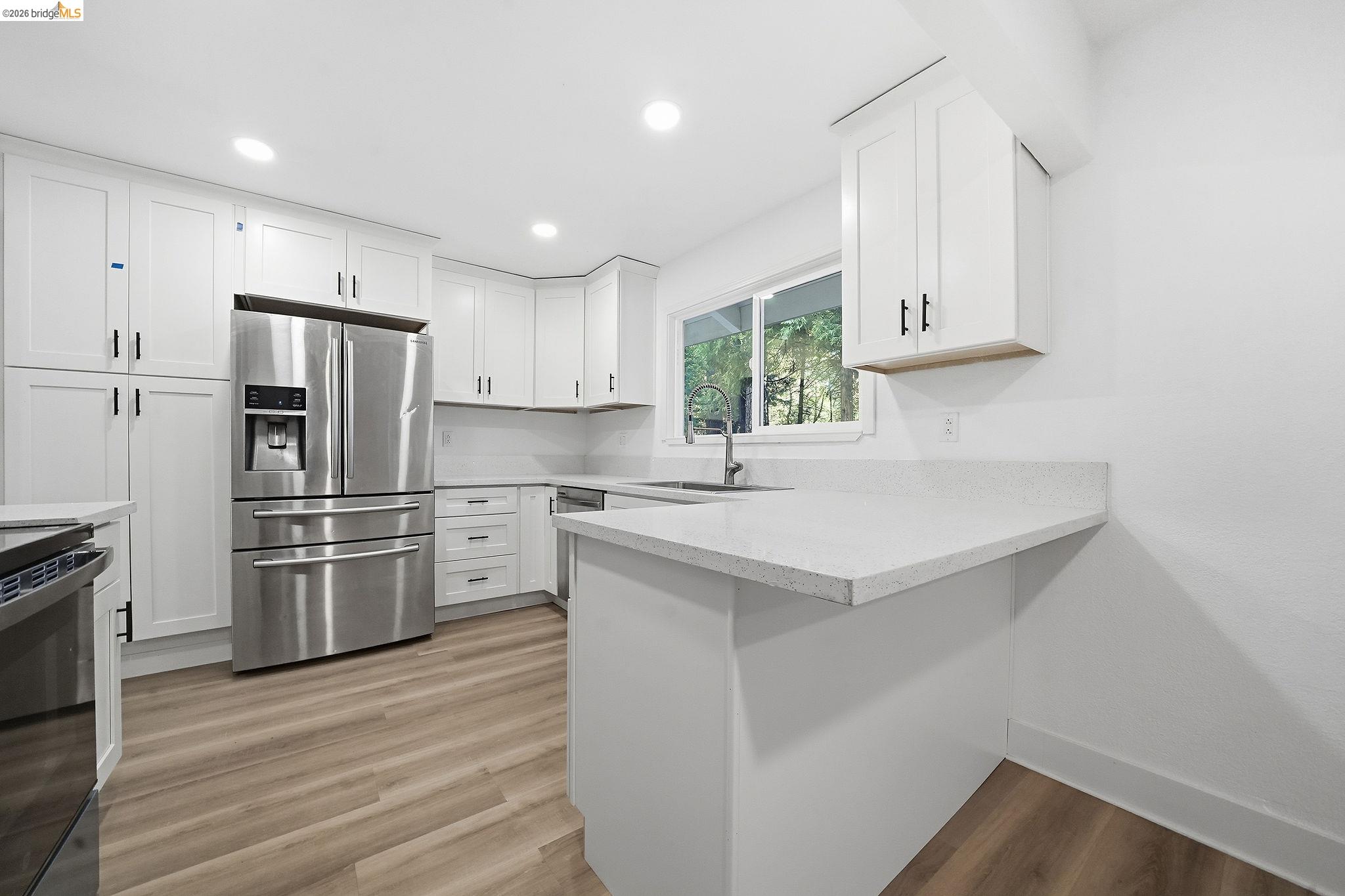 23656 Lightning Pioneer, CA 95666 - Photo 11 of 23 Kitchen featuring stainless steel appliances, white cabinetry, light wood finished floors, a peninsula, and recessed lighting