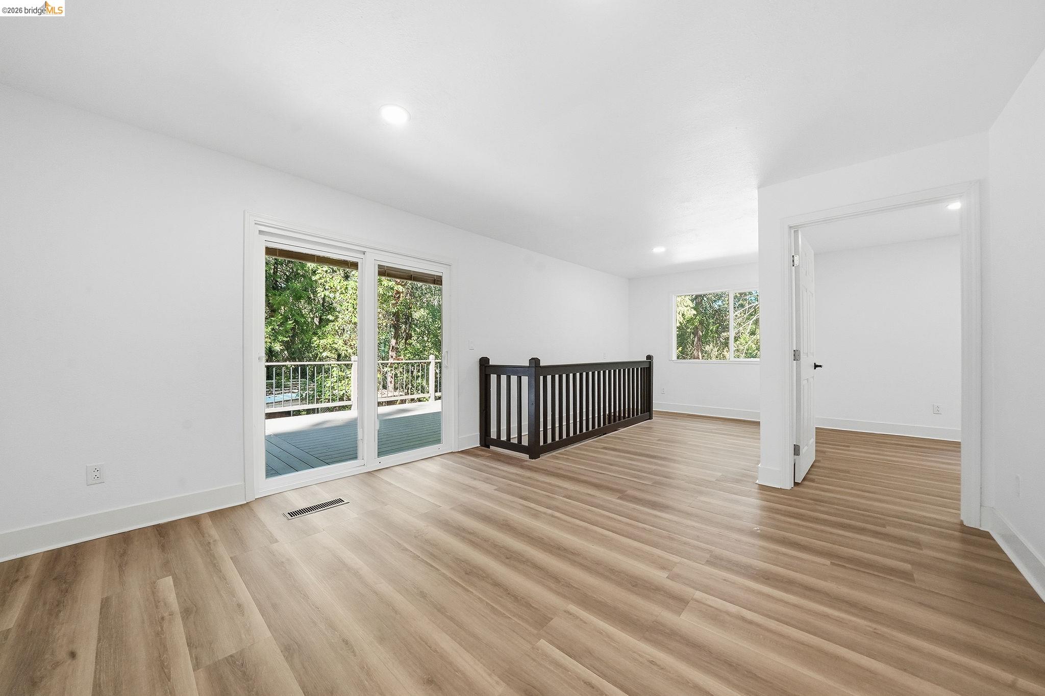 23656 Lightning Pioneer, CA 95666 - Photo 13 of 23 a view of an empty room with wooden floor and a window