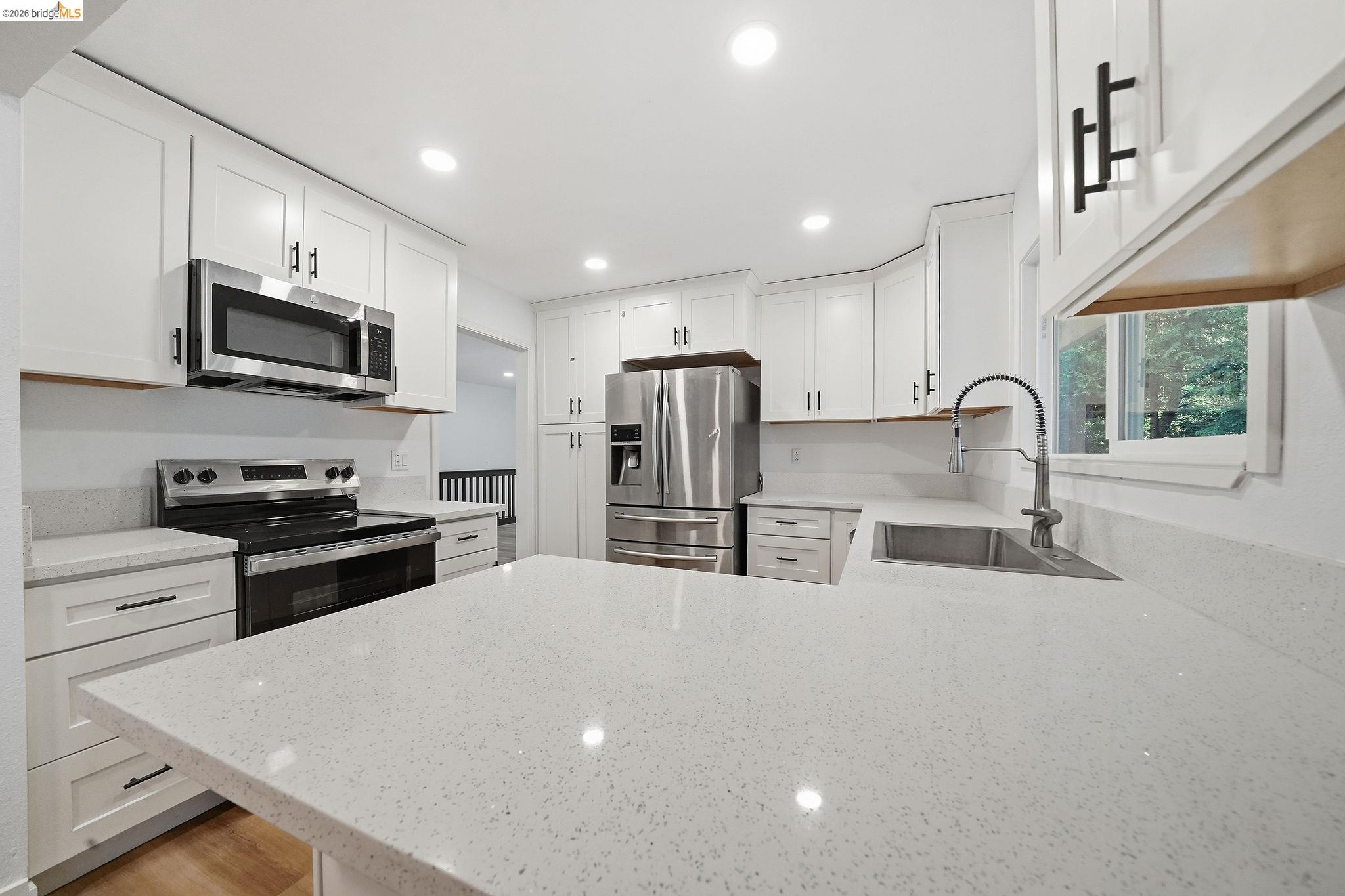23656 Lightning Pioneer, CA 95666 - Photo 12 of 23 Kitchen featuring stainless steel appliances, light stone counters, white cabinetry, a peninsula, and recessed lighting