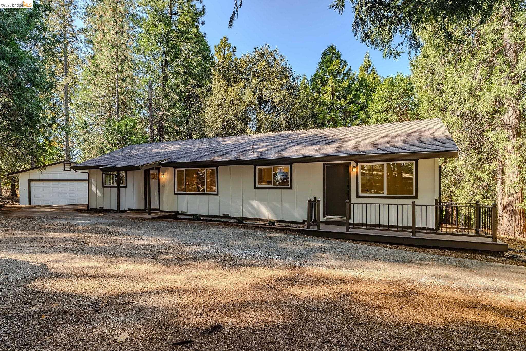 23656 Lightning Pioneer, CA 95666 - Photo 3 of 23 Ranch-style home featuring roof with shingles, an outdoor structure, a garage, and covered porch