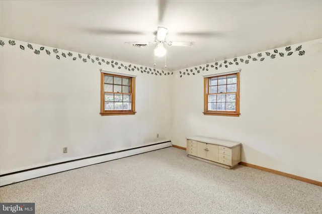 a view of a room with window and ceiling fan