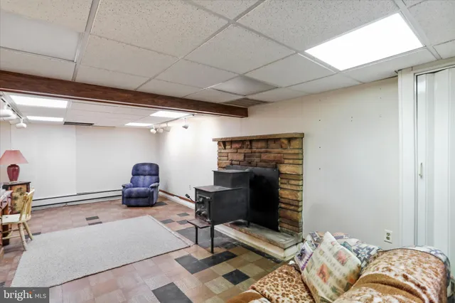 a living room with furniture a rug and a fireplace