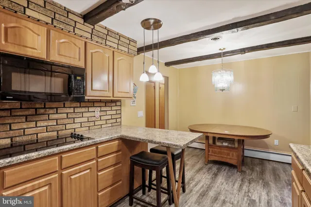 a kitchen with granite countertop a sink appliances and cabinets