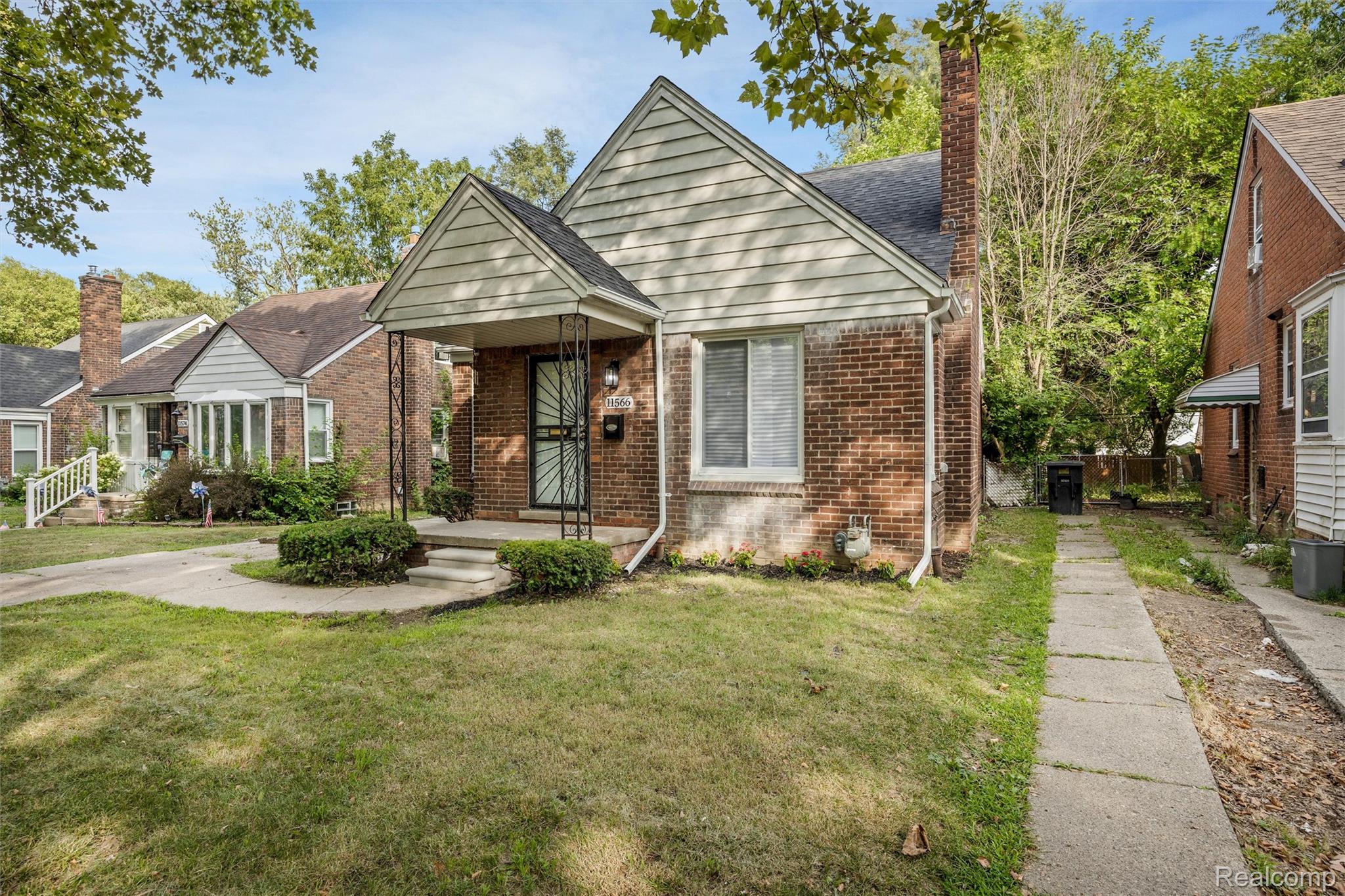 11566 Nottingham Road Detroit, MI 48224 - Photo 2 of 23 Brick exterior with siding gable, covered front porch, and established landscaping
