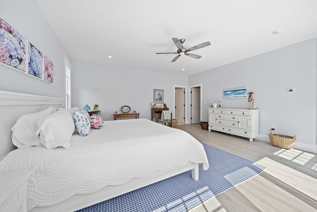 53 Border Street Scituate, MA 02066 - Photo 12 of 34 a bedroom with a bed and a chandelier