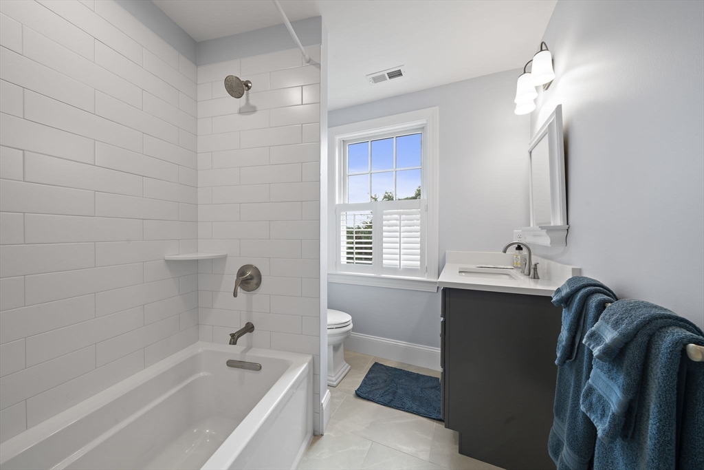 53 Border Street Scituate, MA 02066 - Photo 18 of 34 a bathroom with a bathtub sink vanity mirror and toilet