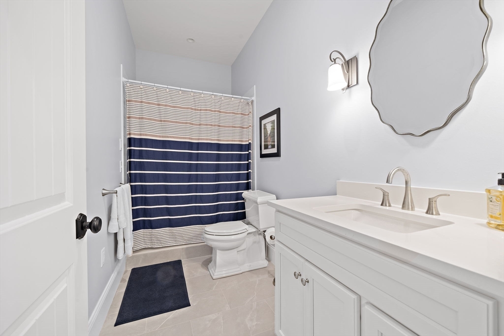 53 Border Street Scituate, MA 02066 - Photo 20 of 34 a bathroom with a sink a toilet and a mirror